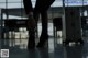 A man and woman standing next to a suitcase in an airport.