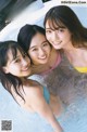 A group of three young women in a swimming pool.