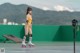 A woman in a yellow bathing suit on roller skates.